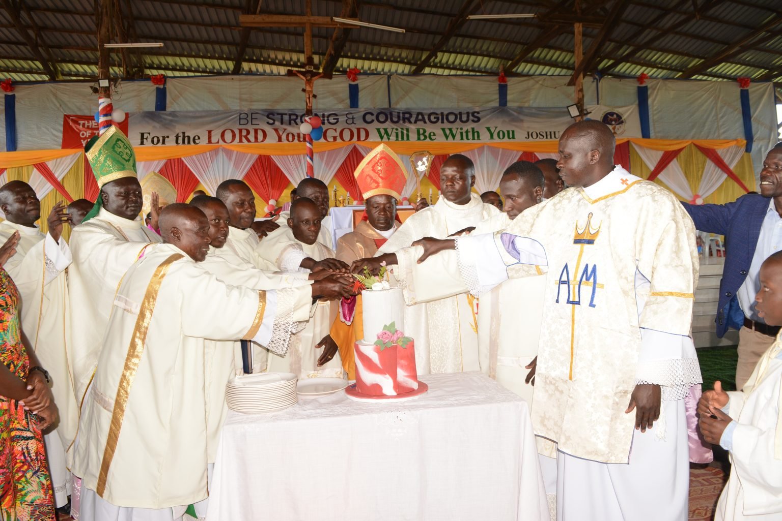 AOCC newly ordained cutting the cut with the Bishops
